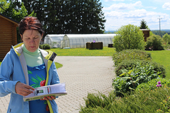 Ilmajaama võitja Ülle Sikk auhinda uurimas,  taamal kasvuhooned,  kus naine veedab  suurema osa suvest.        Foto: AIGAR NAGEL