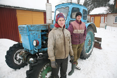 Meremäe valla Miikse kandi mehed Rein Hirvemäe ja Janar Mändla traktori juures, mille abil autod sügavast lumest välja aidati. Foto: Võrumaa Teataja