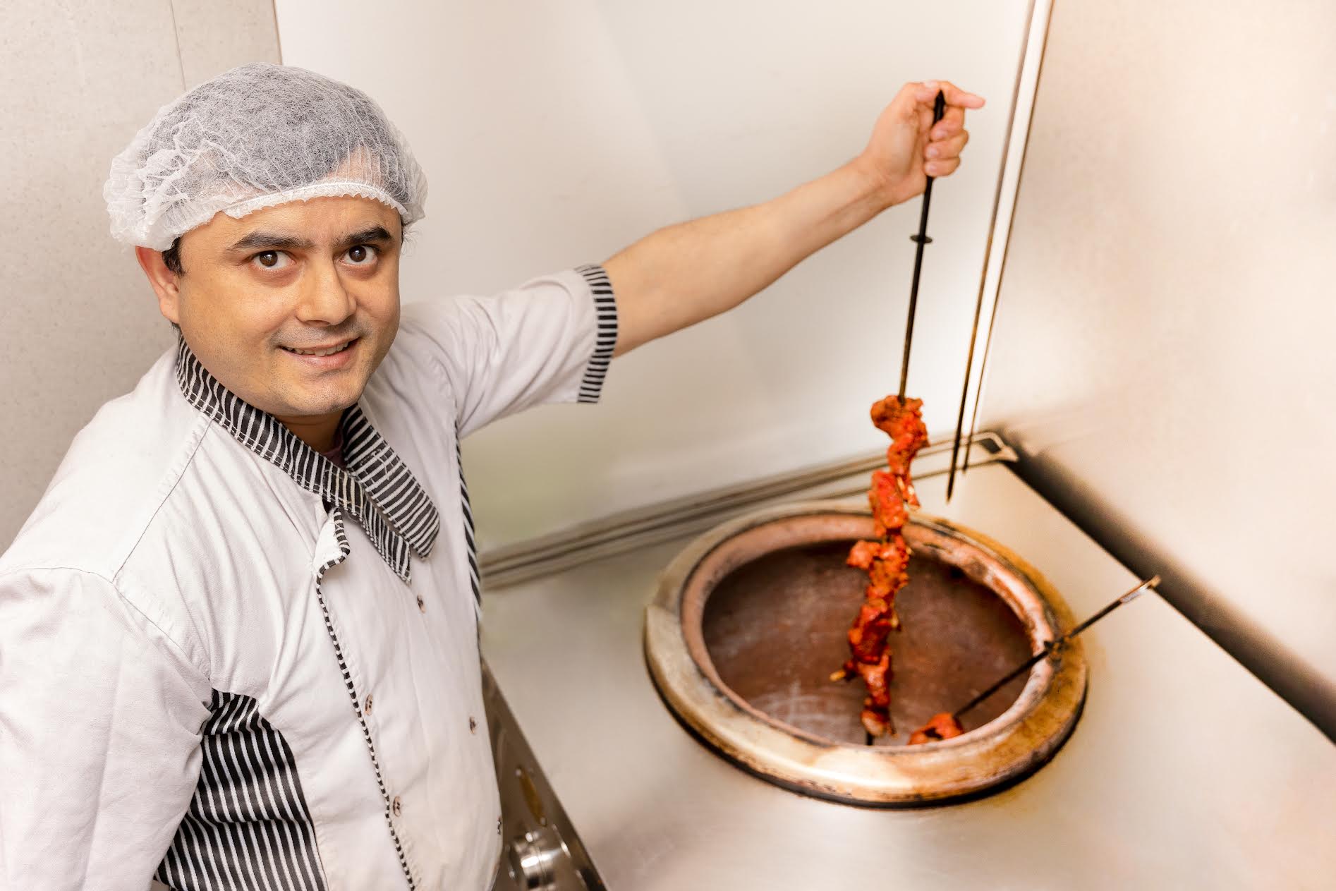 Namaste restorani ja Tandoori House’i omanik Bishnu Prasad Chalise tandoori ahjus, kus söök valmib 280–400 kraadi juures, toitu valmistamas. FOTO: Aigar Nagel