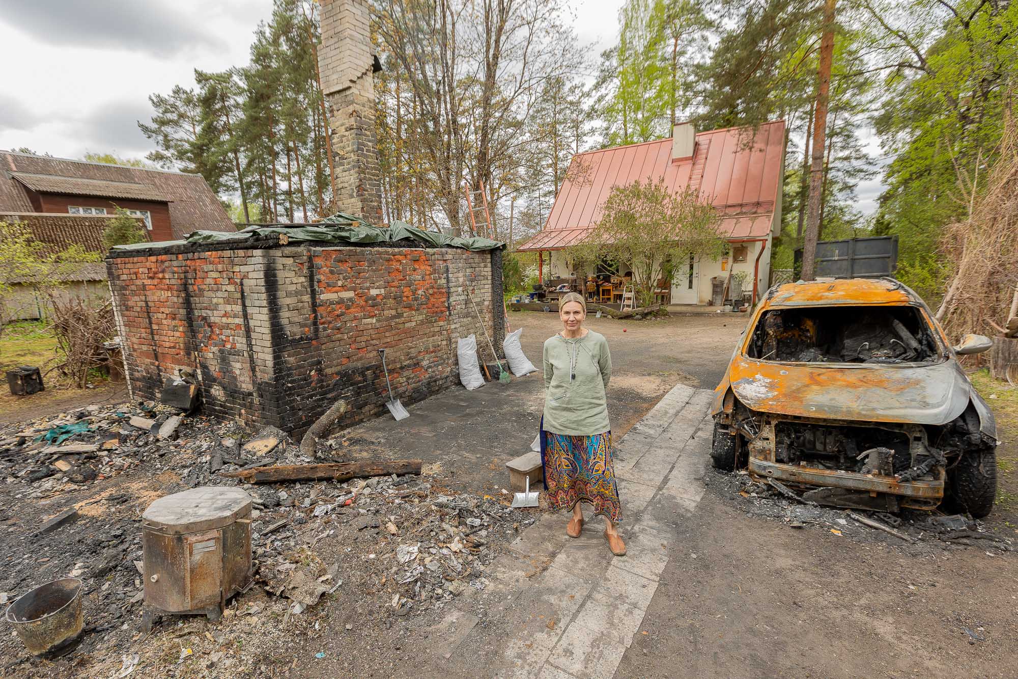 Ruti Jõgi-Rumvolt emadepäeval, 10. mail koduhoovis, kus hävis keraamikatöökoda. Tuli muutis kasutuskõlbmatuks ka kunstniku kuldse auto. FOTOD: Aigar Nagel